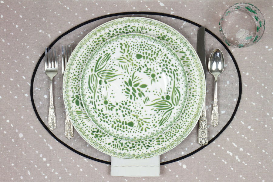Venable Moore Mosaic Garden stacked dinner and salad/dessert  plate in grass green with hand-painted Bubble glass on neutral flax tan 'Staccato Sbiancato' Shibori linen placemat and tablecloth with silverware and white linen napkin
