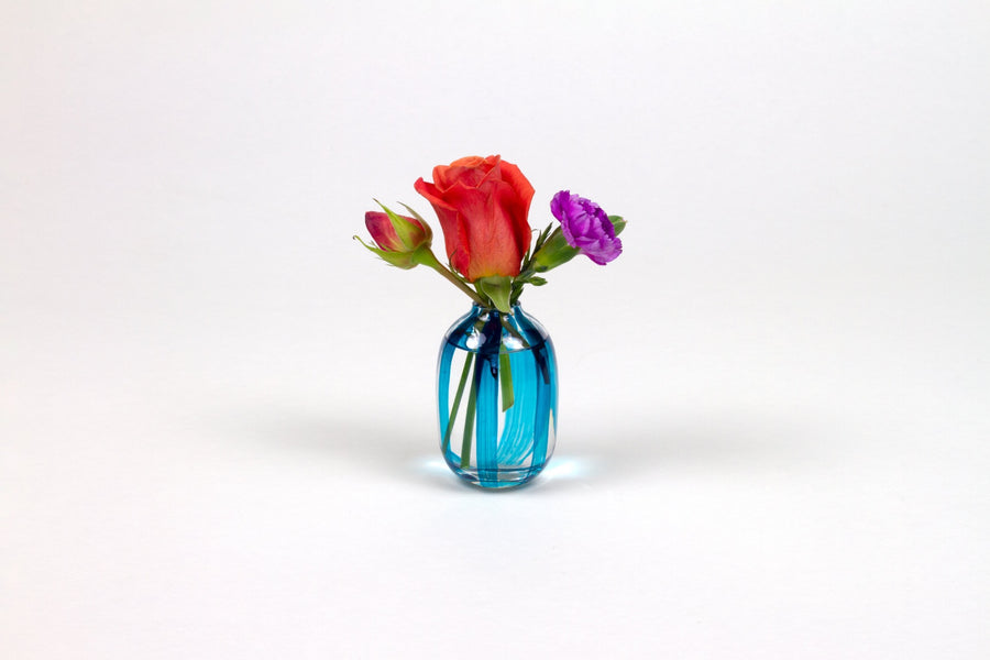 Hand-painted striped glass bud vase in turquoise blue with roses and carnation