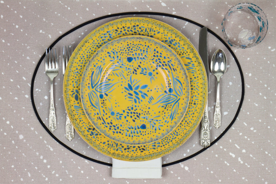 Venable Moore Mosaic Garden stacked dinner and salad/dessert plate in fresh lemon yellow with hand-painted Bubble glass on neutral flax tan 'Staccato Sbiancato' Shibori linen placemat and tablecloth with silverware and white linen napkin