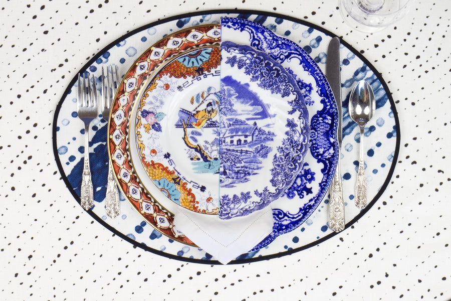 Place setting with 100% linen glissando shibori marine blue placemat on alabaster shibori linen with colored plates