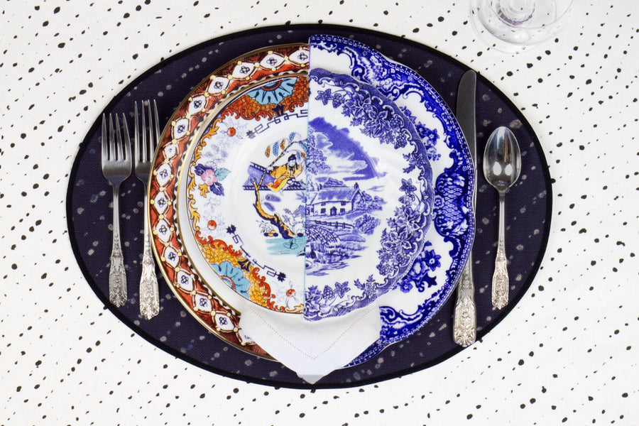 Place setting with 100% linen staccato decolorato shibori midnight blue placemat on alabaster shibori with colored plates