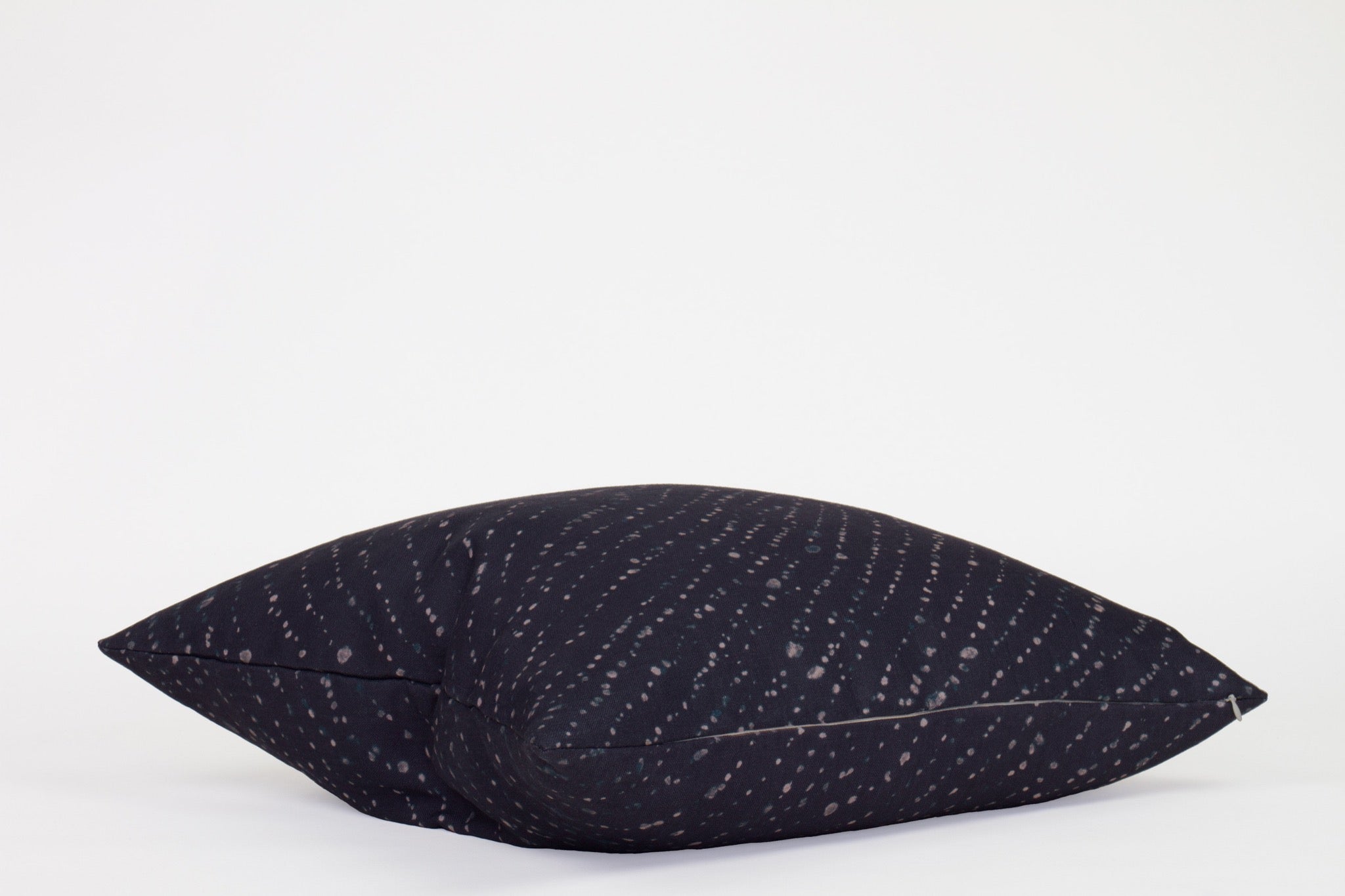 Side view 20” x 20” 100% linen staccato decolorato shibori pillow in midnight blue with hidden zipper