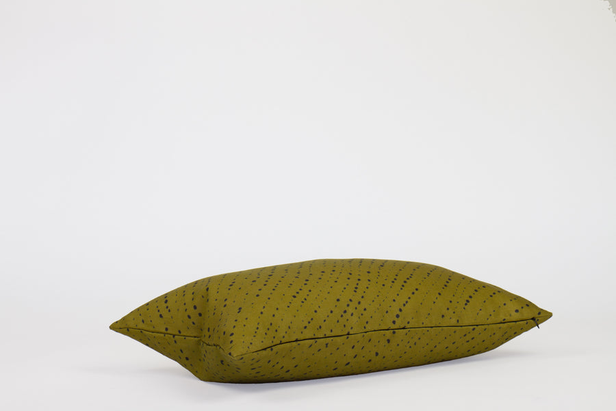 Side view 12” x 20” 100% linen staccato nero shibori pillow in moss green with hidden zippe