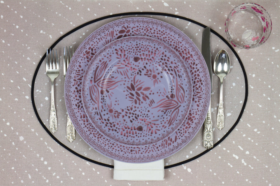 Venable Moore Mosaic Garden stacked dinner and salad/dessert  plate in soft myrtle purple with hand-painted Bubble glass on neutral flax tan 'Staccato Sbiancato' Shibori linen placemat and tablecloth with silverware and white linen napkin