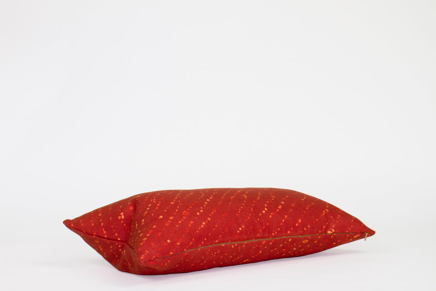 Side view 12” x 20” 100% linen staccato decolorato shibori pillow in paprika red with hidden zipper