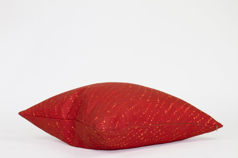 Side view 20” x 20” 100% linen staccato decolorato shibori pillow in paprika red with hidden zipper