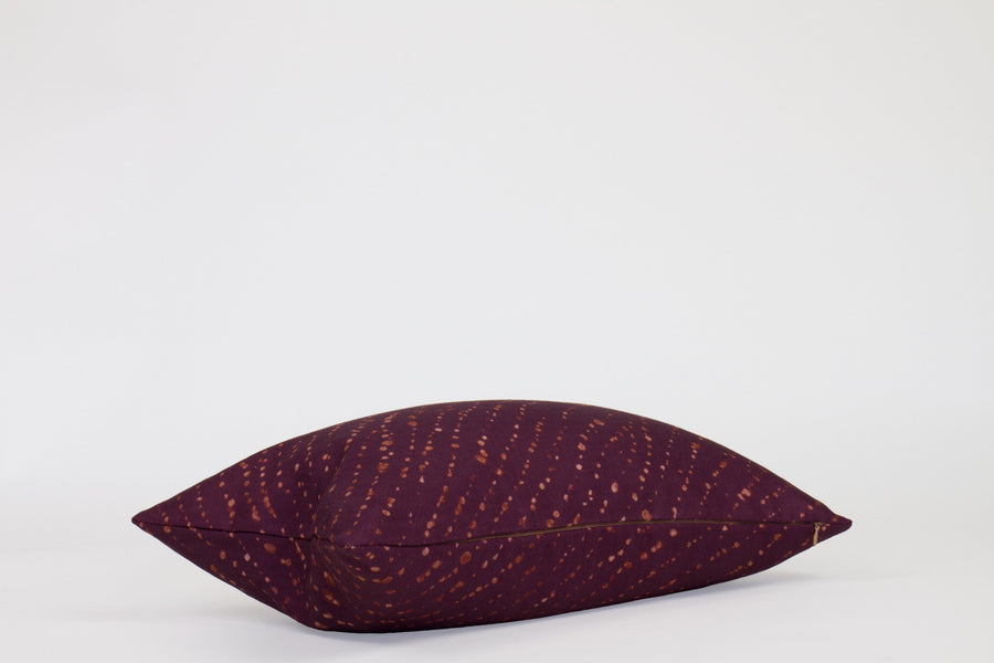 Side view 12” x 20” 100% linen staccato decolorato shibori pillow in plum purple with hidden zipper