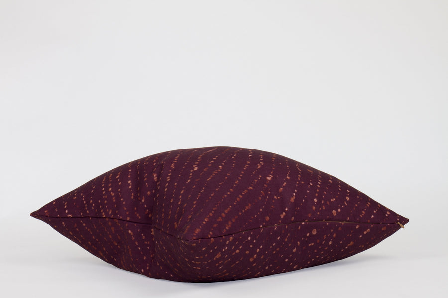 Side view 20” x 20” 100% linen staccato decolorato shibori pillow in plum purple with hidden zipper