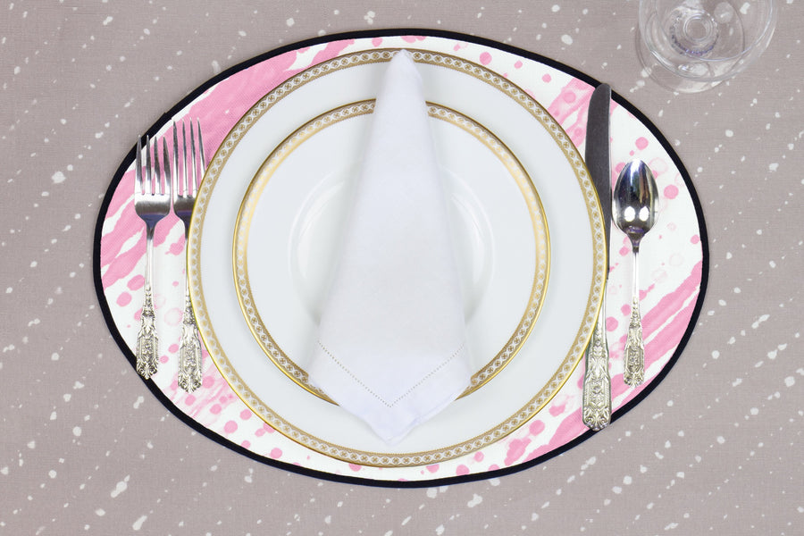 Place setting with 100% linen glissando shibori posy pink placemat on flax shibori linen with white plates
