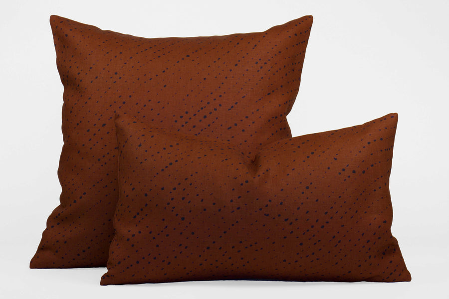 Two 100% linen staccato nero shibori pillows in russet brown, 20” x 20” and 12” x 20”