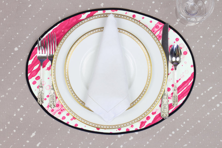 Place setting with 100% linen glissando shibori strawberry pink placemat on flax shibori linen with white plates
