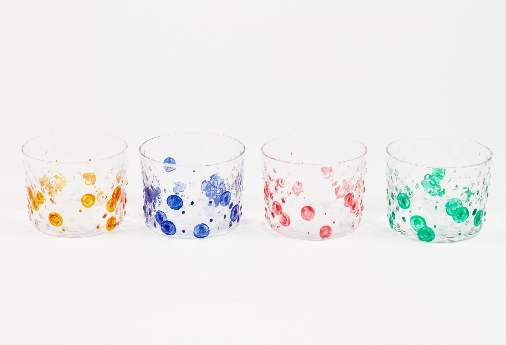 Set of four hand-painted hobnail glasses in tangerine orange, lapis blue, tomato red, and green shamrock